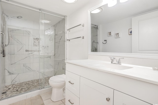 full bath with vanity, tile patterned flooring, a marble finish shower, and toilet