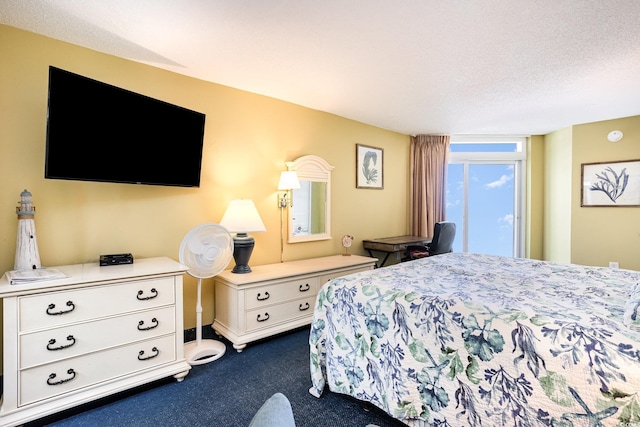 bedroom featuring dark carpet and a textured ceiling