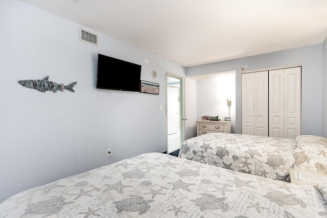 bedroom with visible vents and a closet