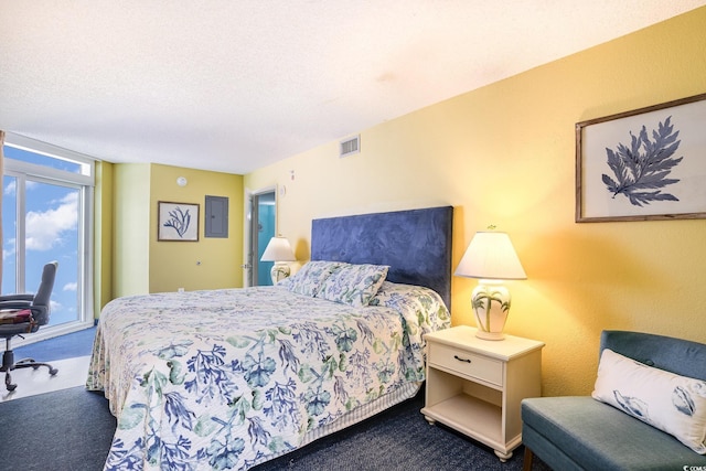 bedroom with carpet floors, visible vents, and a textured ceiling