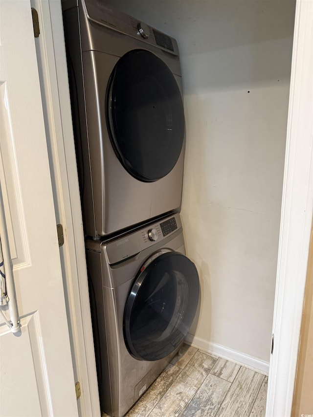 laundry room with stacked washer / dryer