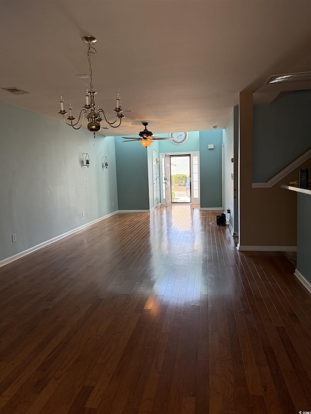 interior space with ceiling fan with notable chandelier and dark hardwood / wood-style flooring