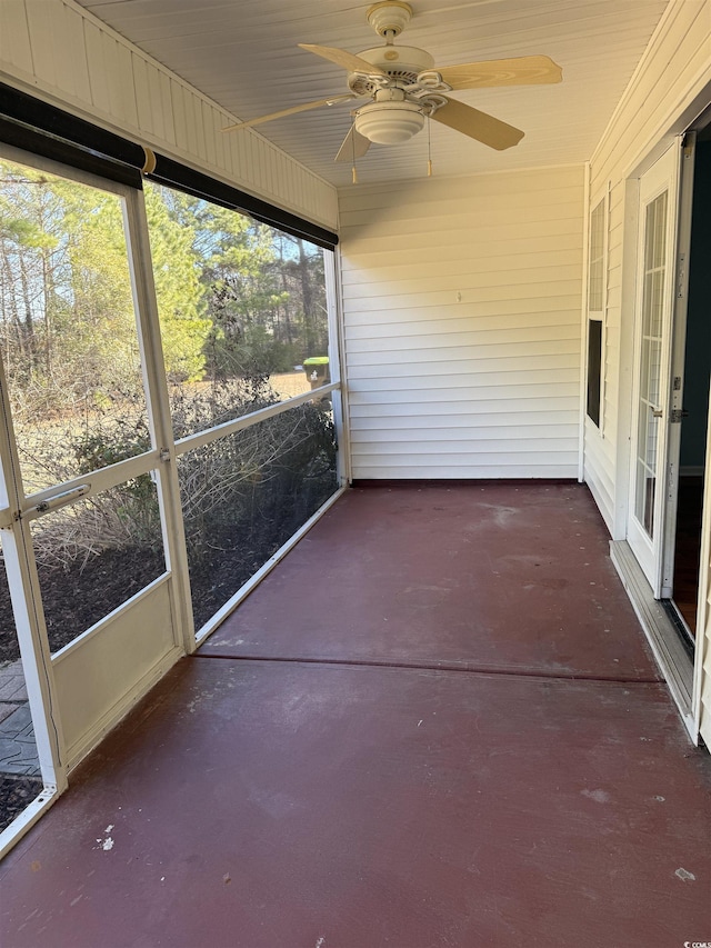 unfurnished sunroom with ceiling fan