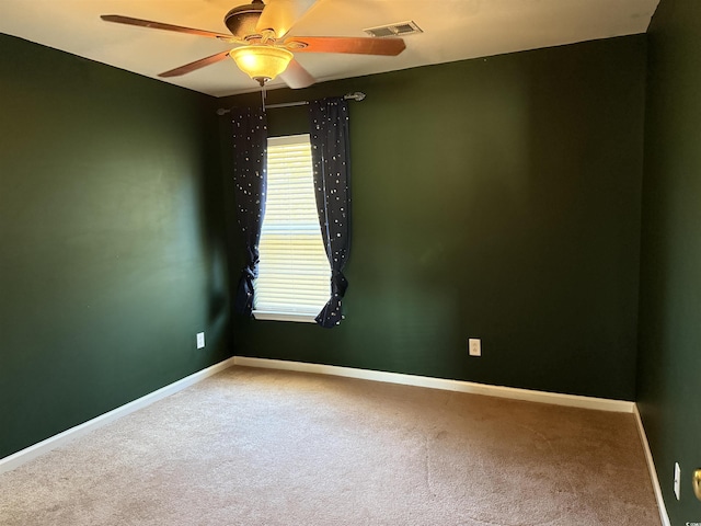 carpeted spare room with ceiling fan