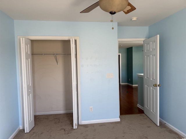 unfurnished bedroom with ceiling fan, a closet, and light colored carpet