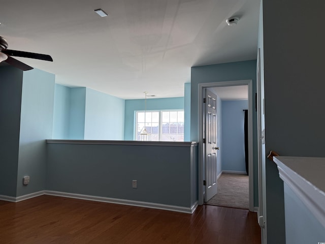 spare room with ceiling fan and dark wood-type flooring