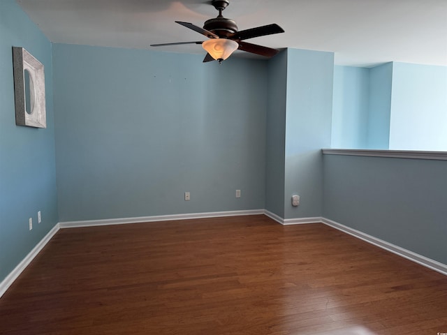 spare room featuring ceiling fan and dark hardwood / wood-style flooring