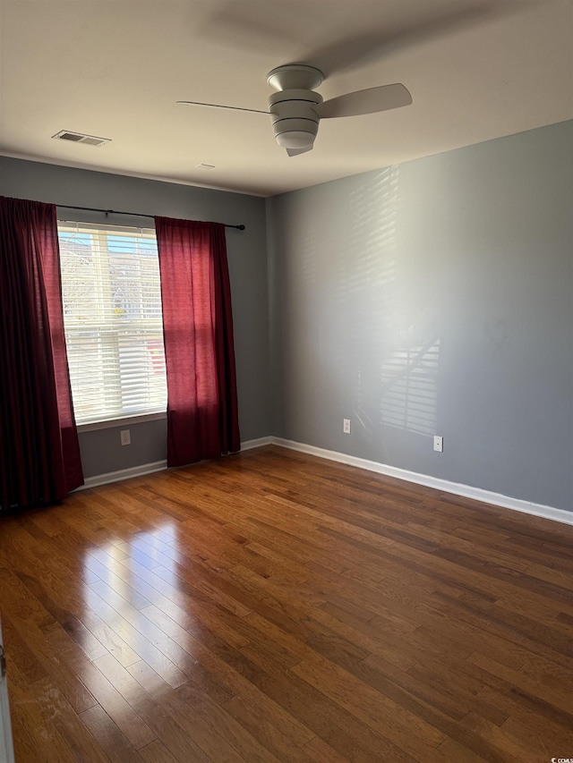 spare room featuring ceiling fan and hardwood / wood-style flooring