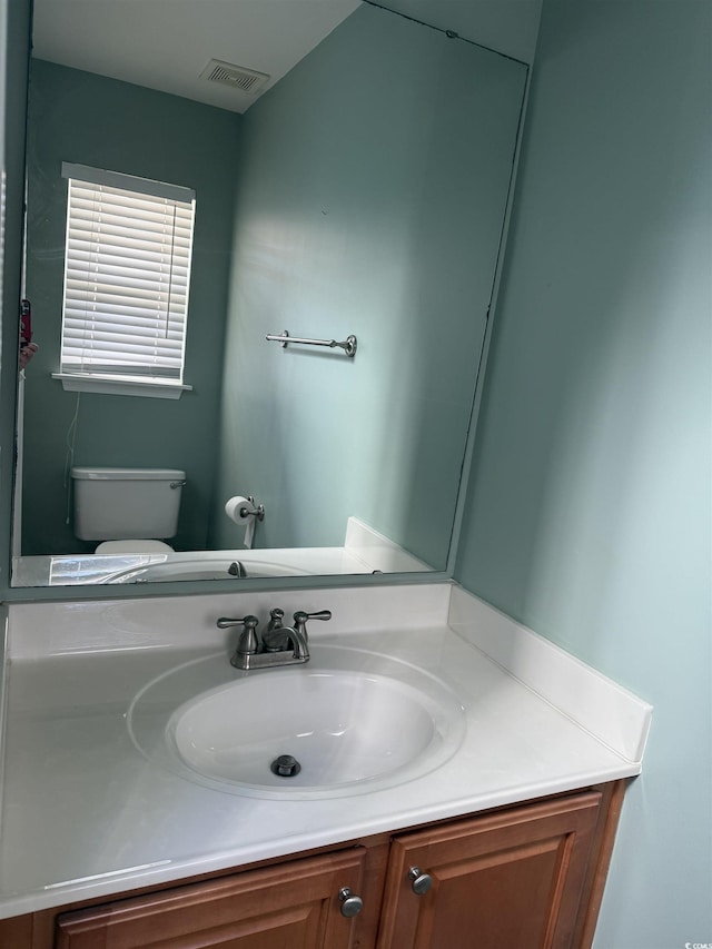 bathroom featuring toilet and vanity