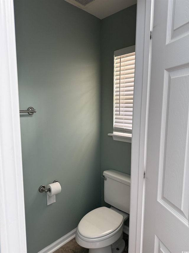 bathroom featuring toilet and tile patterned flooring