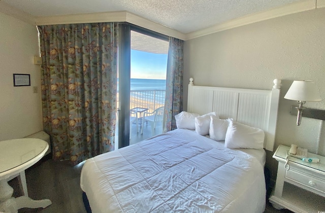 9550 Shore Dr Unit 1226, Myrtle Beach, SC 29572 - bedroom featuring crown molding, a textured ceiling, and a water view