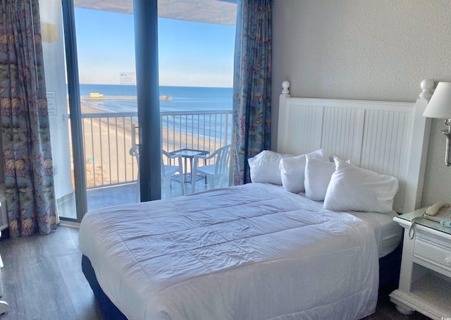 9550 Shore Dr Unit 1226, Myrtle Beach, SC 29572 - bedroom featuring a water view, wood finished floors, and a textured wall