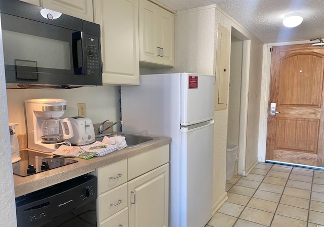 9550 Shore Dr Unit 1226, Myrtle Beach, SC 29572 - kitchen with a sink, a textured ceiling, light tile patterned flooring, black appliances, and light countertops