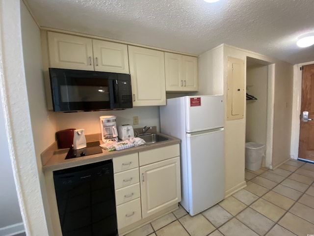 9550 Shore Dr Unit 1226, Myrtle Beach, SC 29572 - kitchen featuring a sink, light tile patterned flooring, black appliances, and white cabinets