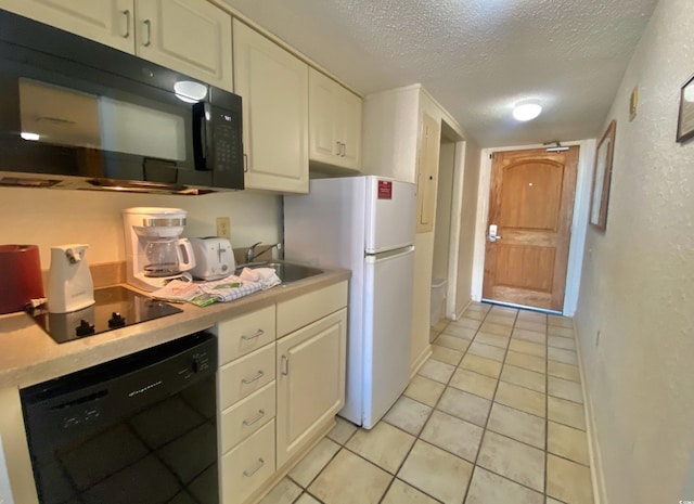 9550 Shore Dr Unit 1226, Myrtle Beach, SC 29572 - kitchen featuring a sink, a textured ceiling, black appliances, and white cabinets