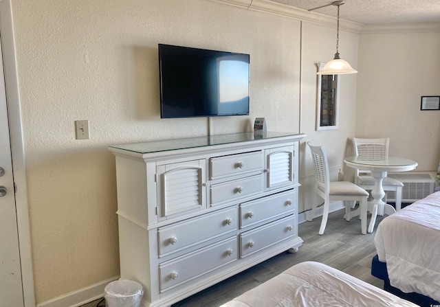 9550 Shore Dr Unit 1226, Myrtle Beach, SC 29572 - bedroom with ornamental molding, a textured ceiling, and wood finished floors