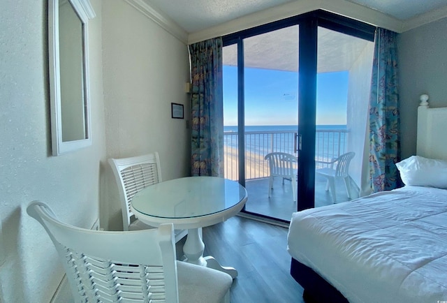 9550 Shore Dr Unit 1226, Myrtle Beach, SC 29572 - bedroom featuring a water view, crown molding, wood finished floors, access to exterior, and a textured wall