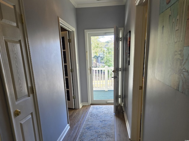 doorway to outside with ornamental molding and hardwood / wood-style floors