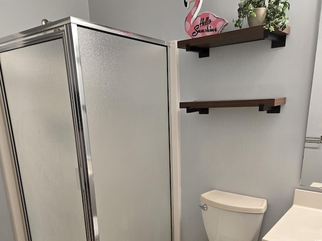 bathroom with toilet and walk in shower