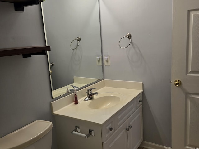 bathroom with toilet and vanity