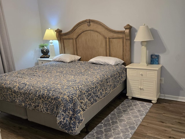 bedroom with dark hardwood / wood-style flooring