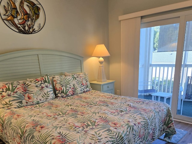 bedroom with multiple windows and hardwood / wood-style floors