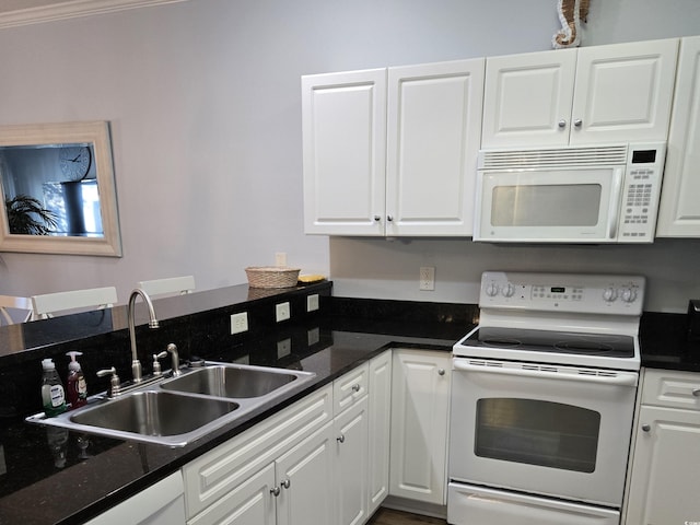 kitchen featuring white appliances, white cabinetry, dark stone counters, sink, and ornamental molding