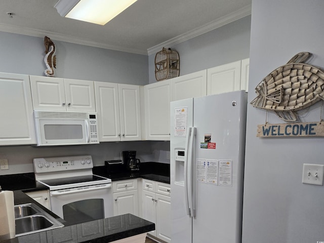 kitchen with white appliances, white cabinets, and crown molding