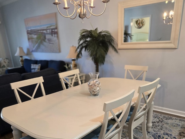 dining area featuring an inviting chandelier and hardwood / wood-style flooring