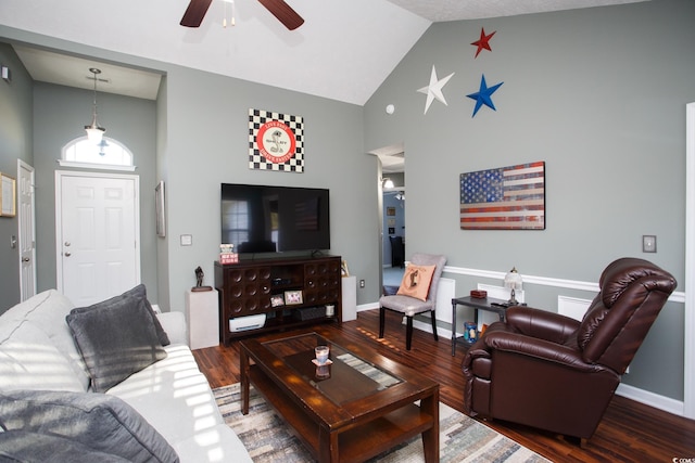 living area with a ceiling fan, wood finished floors, and baseboards