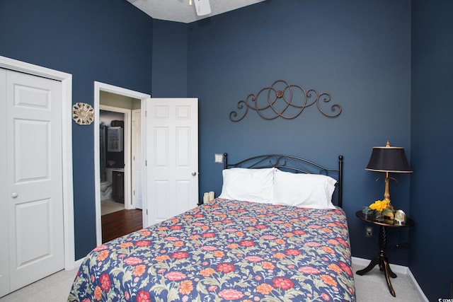 carpeted bedroom featuring vaulted ceiling, a ceiling fan, and baseboards