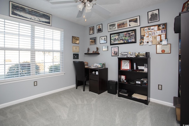 home office featuring baseboards, carpet, and a ceiling fan