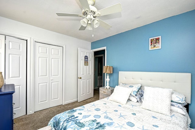 carpeted bedroom featuring two closets and ceiling fan