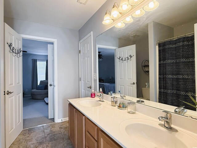 bathroom featuring toilet, ceiling fan, and walk in shower