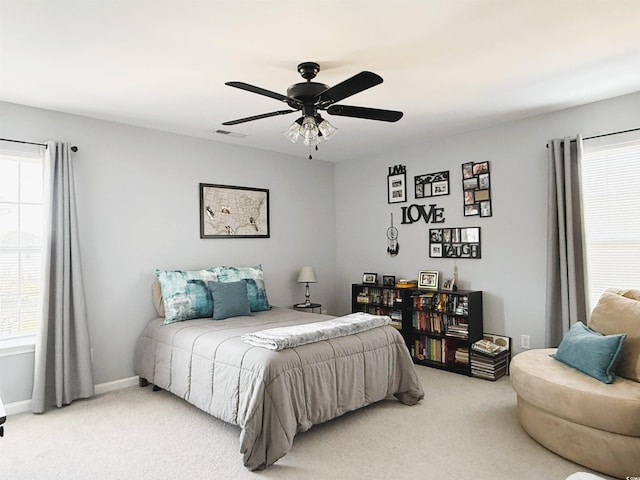 bedroom featuring carpet, visible vents, and multiple windows