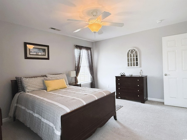 bedroom featuring light carpet, baseboards, visible vents, and a ceiling fan