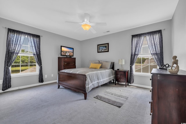bedroom with multiple windows, baseboards, and carpet floors