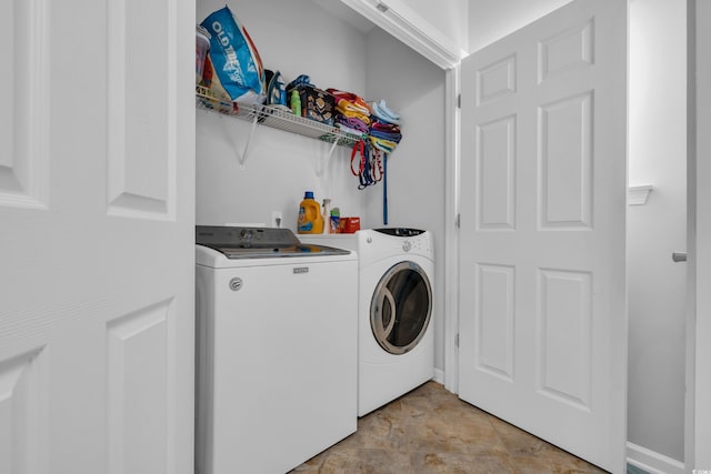 clothes washing area featuring washer and dryer