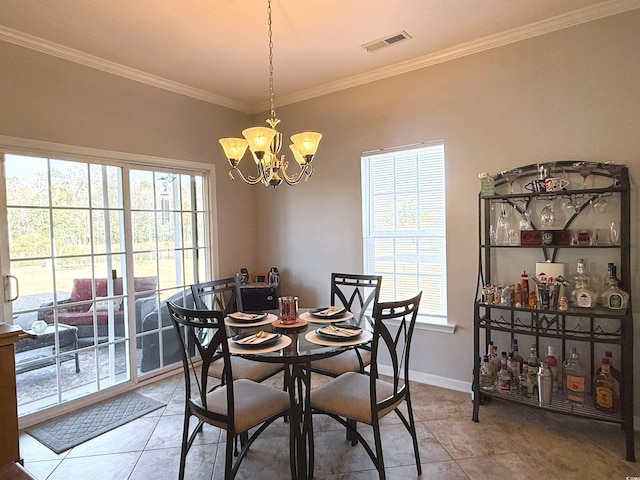 tiled dining room with a wealth of natural light, visible vents, crown molding, and baseboards