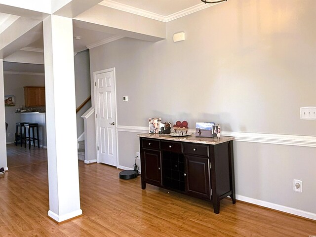 living room featuring ornamental molding, light hardwood / wood-style floors, and plenty of natural light