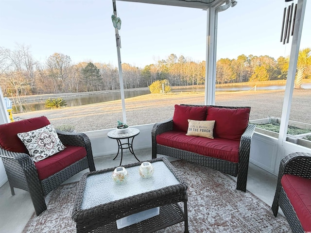 sunroom with a water view and a view of trees