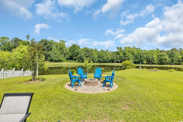 view of yard with an outdoor fire pit, a water view, and a patio area