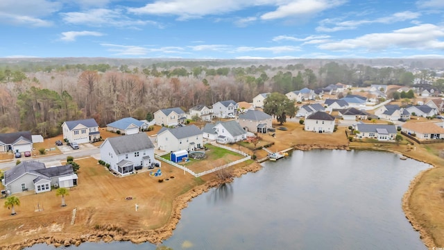 drone / aerial view featuring a residential view and a water view