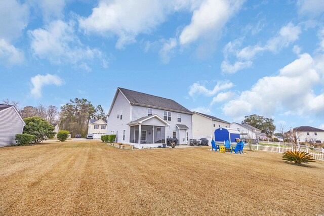 back of house with a sunroom and a patio