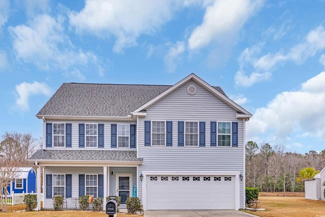 view of front of house with a garage and a front yard