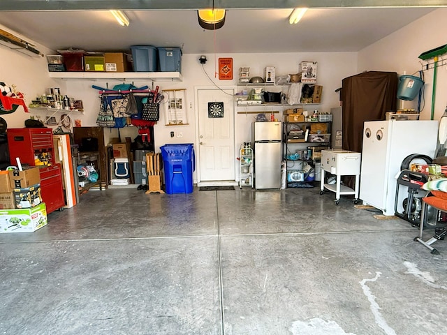 garage featuring a workshop area and stainless steel refrigerator