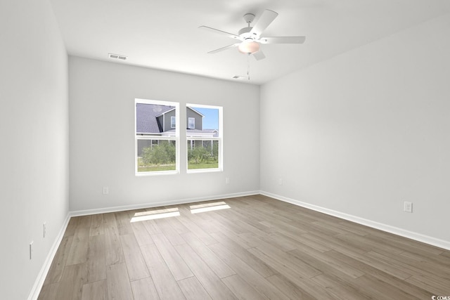 empty room with ceiling fan and light wood-type flooring