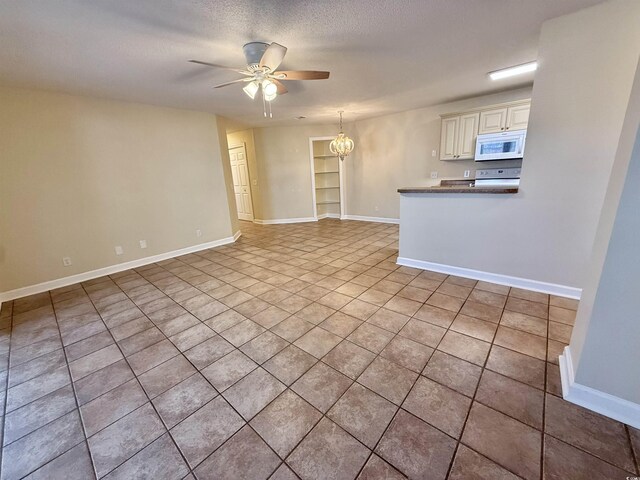 4273 Santolina Way Unit E, Murrells Inlet, SC 29576 - unfurnished living room with a ceiling fan, light tile patterned floors, baseboards, a textured ceiling, and a chandelier