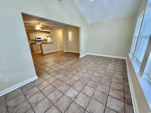 4273 Santolina Way Unit E, Murrells Inlet, SC 29576 - unfurnished living room featuring ceiling fan, light tile patterned floors, baseboards, and vaulted ceiling