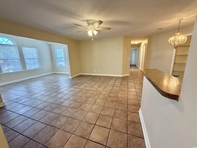 4273 Santolina Way Unit E, Murrells Inlet, SC 29576 - unfurnished room featuring ceiling fan, light tile patterned floors, a chandelier, a textured ceiling, and baseboards